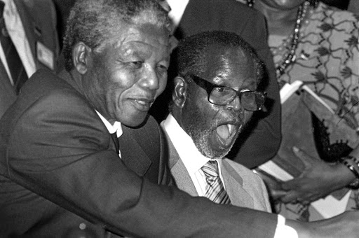 Tambo, with Nelson Mandela next to him, receives a gift