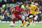 Sadio Mane (left) of Liverpool in action against Ruben Neves of Wolverhampton in the English Premier League match at Anfield in Liverpool May 22 2022. 
