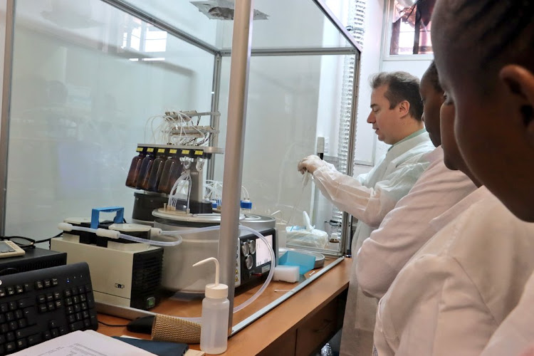 Staff inside the new laboratory platform for research in new and re-emerging pandemics and outbreak containment at KEMRI headquarters