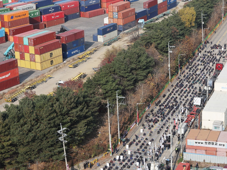 Unionized truckers shout slogans during their rally as they kick off their strike in front of transport hub in Uiwang, south of Seoul, South Korea November 24, 2022.