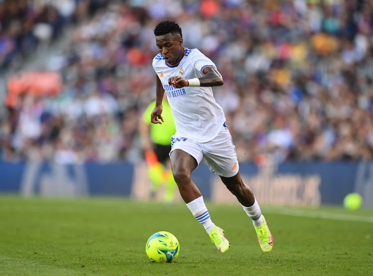 Vinicius Jr runs with the ball during the La Liga Santander match between Barcelona and his club Real Madrid at Camp Nou on October 24, 2021 in Barcelona, Spain.