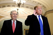 US President Donald Trump listens to a question from reporters next to Senate Majority Leader Mitch McConnell as he arrives for a closed Senate Republican policy lunch on Capitol Hill in Washington, US, on March 26 2019. 