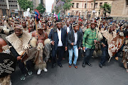 Prince Simphiwe Zulu, (in green) together with a group of Amabutho, gathered outside Pretoria High Court pledging support to King Misuzulu Zulu. 