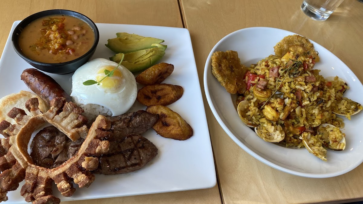 Bandeja paisa on the left and paella on the right