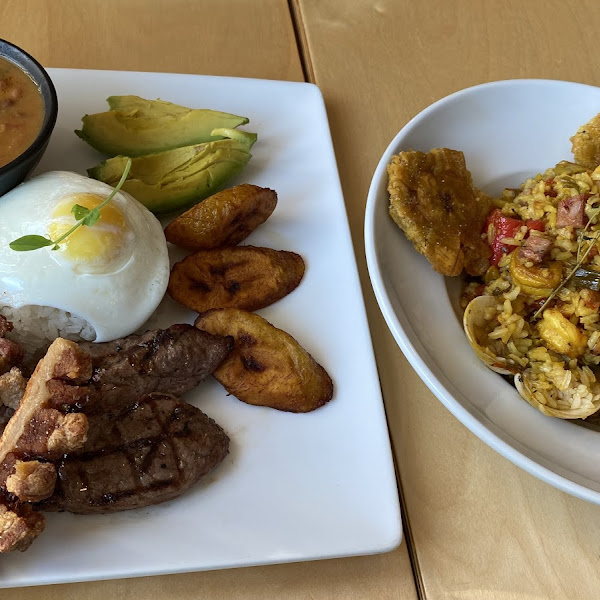 Bandeja paisa on the left and paella on the right