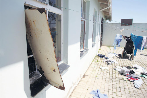 APPALLING CONDITIONS: Broken windows and doors are the norm at a Mdantsane school near East London. Left, a pupil hangs up his own laundry at the school , which employs over 10 cleaners. Middle, there is no privacy in the toilets , which pupils are forced to use together. Right, a tap is left running in a boys’ toilet. Pictures: ALAN EASON