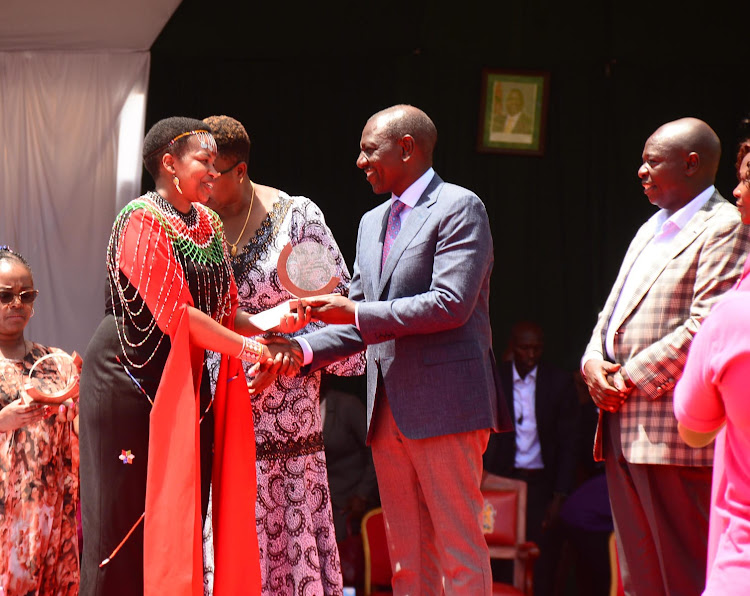 Jackline Saleiyan receives an award from President William Ruto. Image: Handout.