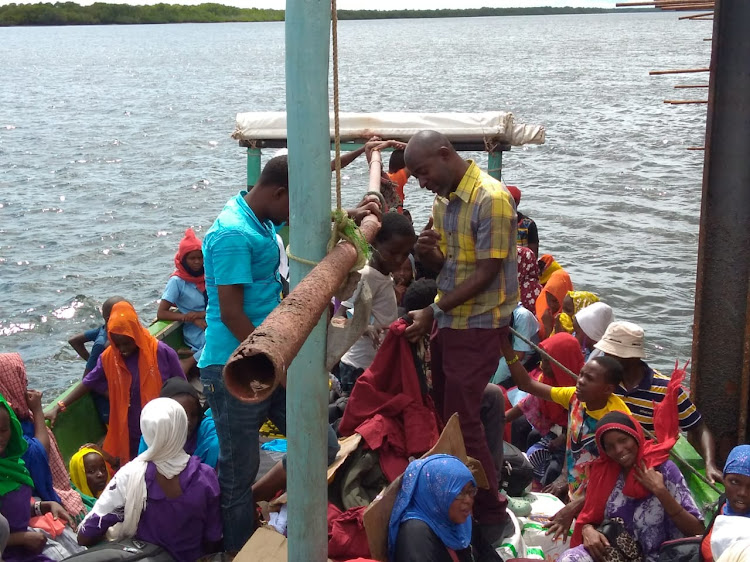 Boni learners being ferried to school on a boat.