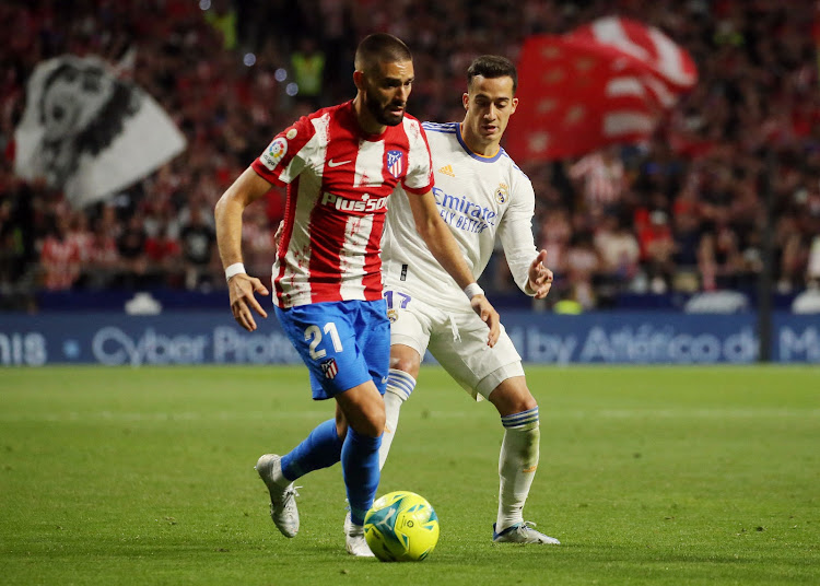 Atletico Madrid's Yannick Carrasco in action with Real Madrid's Lucas Vazquez