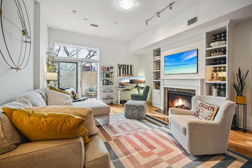 Modern living room with fireplace and sofa in this luxury apartment / penthouse for sale in Washington ($479,999)