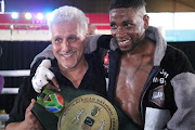 Alan Toweel Junior celebrates with his newly crowned SA featherweight champ Jeff Magagane who dethroned Asanda Ginqgi on points at the Portuguese Hall.