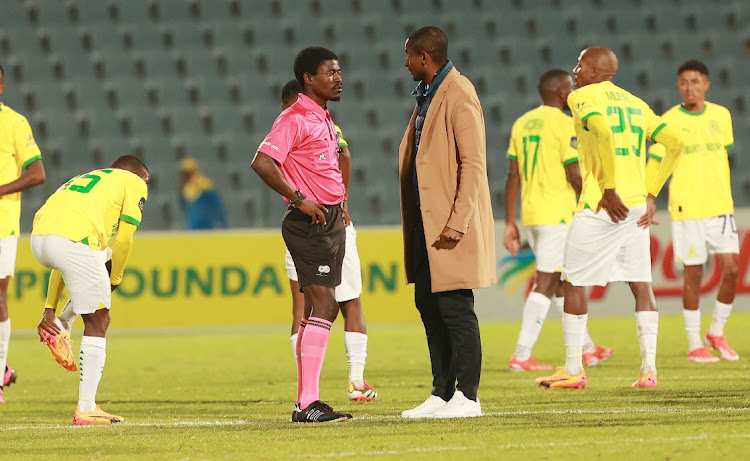 Referee Jelly Chavani and Sundowns coach Rulani Mokwena face-off during the PSL match between Downs and Swallows on Monday.