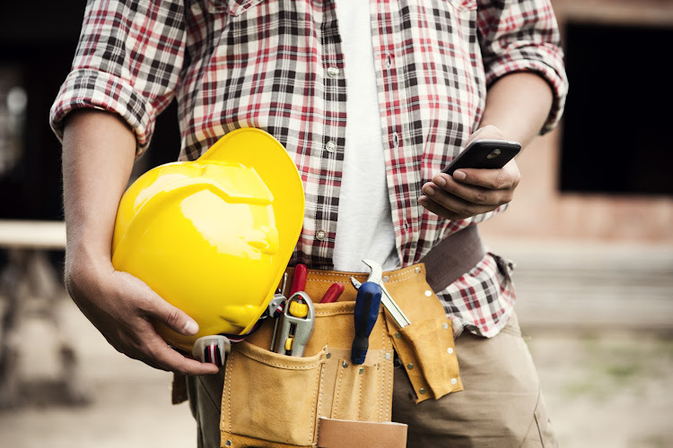 close-up-of-construction-worker-texting-on-mobile-phone.jpg