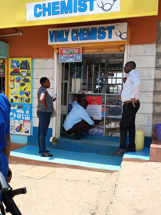 Officials from the PPB issue a closure notice to an illegal pharmacy outlet in a joint crackdown conducted in Western and Nairobi on Saturday, March 19, 2022.