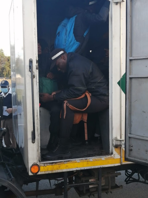 Fidelity security guards in the back of a truck.