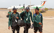 Bafana Bafana players, left to right, Khuliso Mudau, Mothobi Mvala and Terrence Mashego disembark from their plane arriving in Yamoussoukro, Ivory Coast before Saturday's Africa Cup of Nations quarterfinal against Cape Verde at Stade Charles Konan Banny.