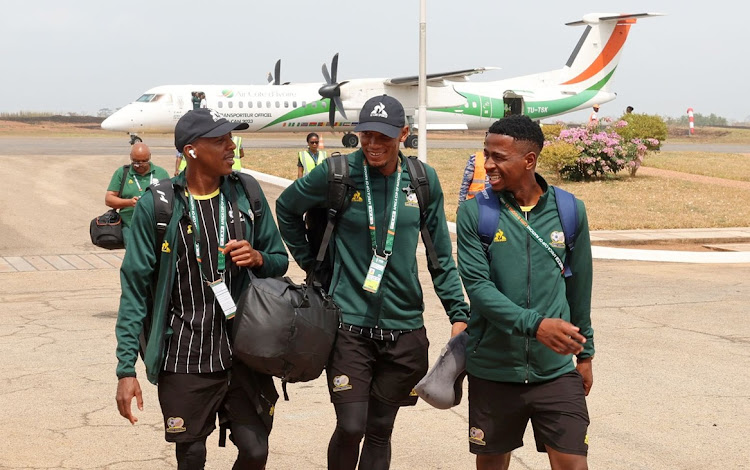 Bafana Bafana players, left to right, Khuliso Mudau, Mothobi Mvala and Terrence Mashego disembark from their plane arriving in Yamoussoukro, Ivory Coast before Saturday's Africa Cup of Nations quarterfinal against Cape Verde at Stade Charles Konan Banny.