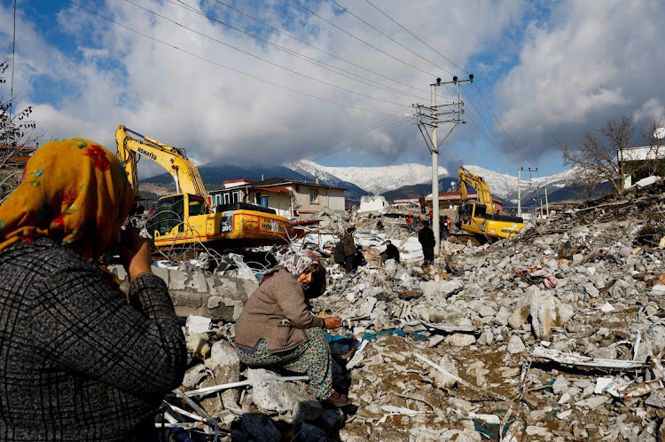 A woman reacts as she sits amidst rubble and damages following an earthquake in Gaziantep, Turkey, on February 7 2023. Picture: SUHAIB SALEM/REUTERS