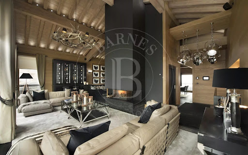 Spacious living room with fireplace and modern furniture in this luxury property for seasonal rental in Courchevel (1,500 m²)