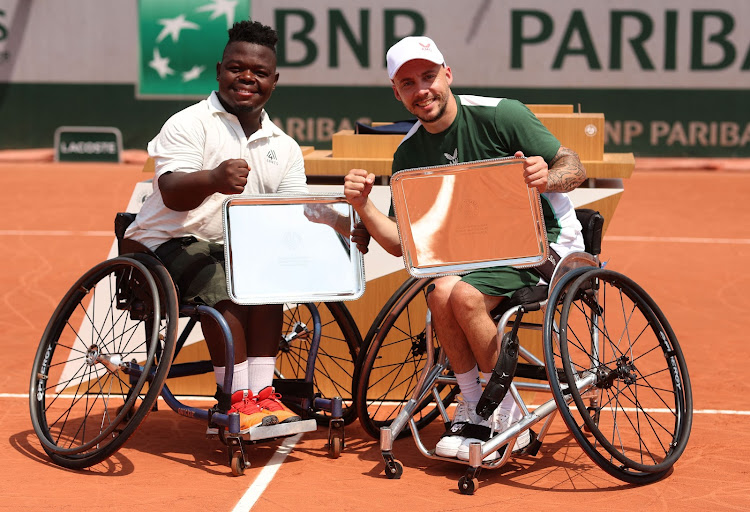 Partners Donald Ramphadi of SA and Andy Lapthorne of Great Britain with their trophies after victory over Heath Davidson of Australia and Robert Shaw of Canada in the men’s quad wheelchair singles final of the French Open at Roland Garros in Paris on Saturday. Picture: JULIAN FINNERY/GETTY IMAGES