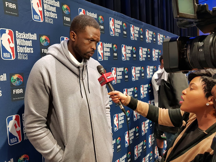 Team Africa co-captain Luol Deng doing media interviews.