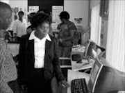 INFORMATION HIGHWAY: Limpopo sports, arts and culture MEC Joyce Mashamba checks one of the computers donated by her department to the Letsitele library. Pic. Michael Sakuneka. 07/09/08. © Sowetan.