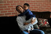 Tshepo Moropa holds baby Phenyo Moropa in Midrand. 