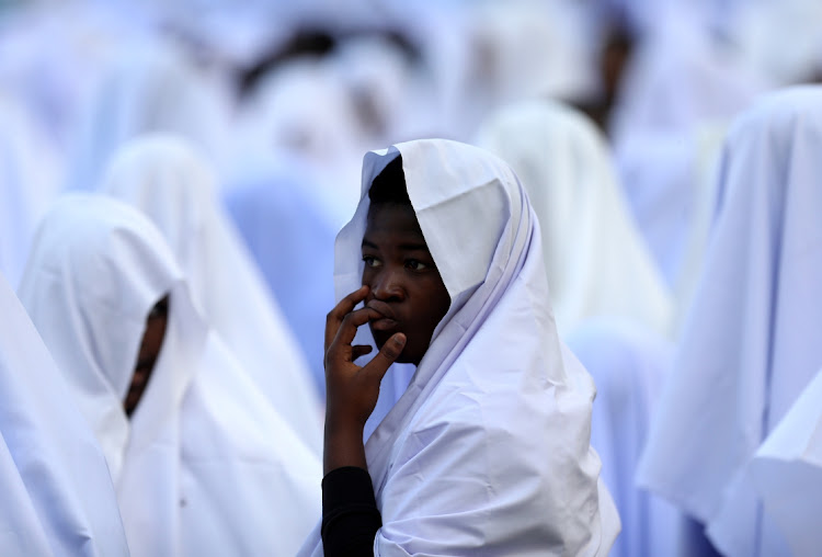 A girl photographed during prayers at Moses Mabhida Stadium.