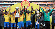 Mamelodi Sundowns players and technical staff celebrate lifting the Shell Helix Ultra Cup match after their 2-1 win over rivals Kaizer Chiefs at the FNB Stadium, Johannesburg on July 21 2018.