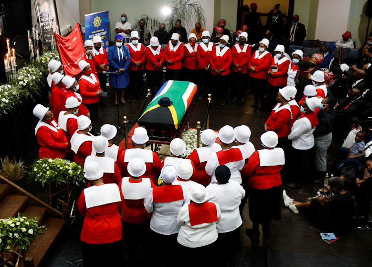 Women in church uniforms gather around the coffin of police diver Sgt Busisiwe Mjwara, who died while searching for flood victims, at her official funeral in Pietermaritzburg on April 22 2022.