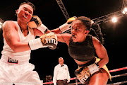 Zimbabwean Cindy Ncube, left, and Matshidiso Mokebisi exchange blows during their ABU SADC fight which the Free Stater won by a split points decision at the Portuguese Hall, Johannesburg.