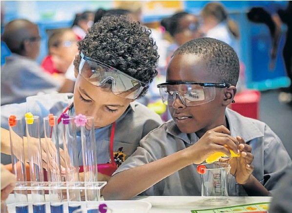 Lisa Mose, right, offers advice as Zozi Adam records their experiment at BASF Kids Lab on the opening day of Scifest 2018. The Kingswood College grade 4s are among thousands of pupils who attend Scifest every year