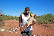 Nelson Muleya holds a bone of a bull elephant  shot by rangers in the village of Sigonde, Limpopo. 