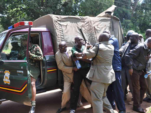 Senator Boni Khalwale (in green polo shirt) is arrested by police in Kakamega town on Monday /SAMUEL SIMITI