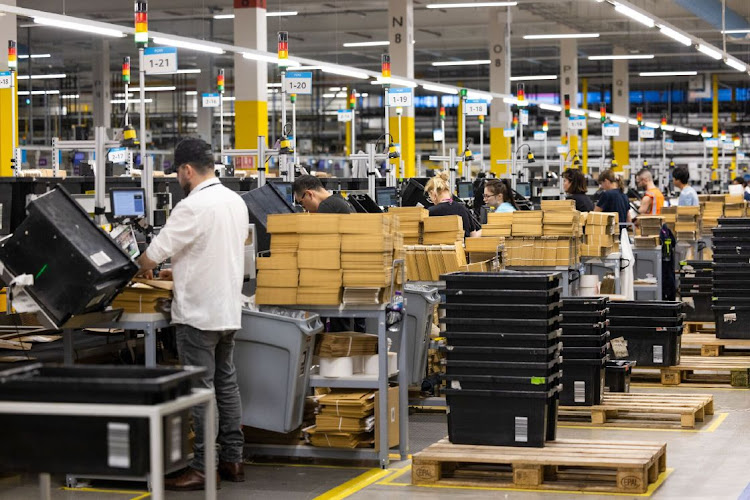 Employees pack boxes at the Amazon fulfillment centre in Dartford, UK. Picture: BLOOMBERG/CHRIS RATCLIFFE