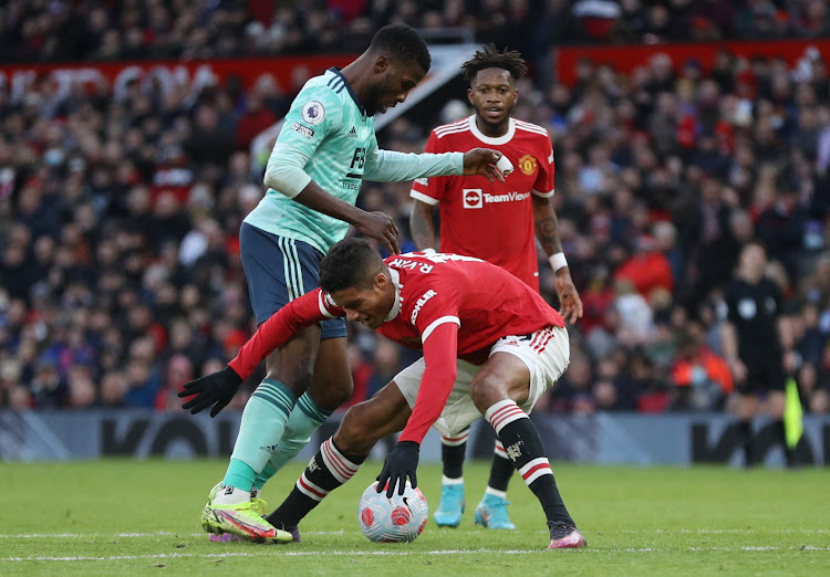 Leicester City's Kelechi Iheanacho fouls Manchester United's Raphael Varane