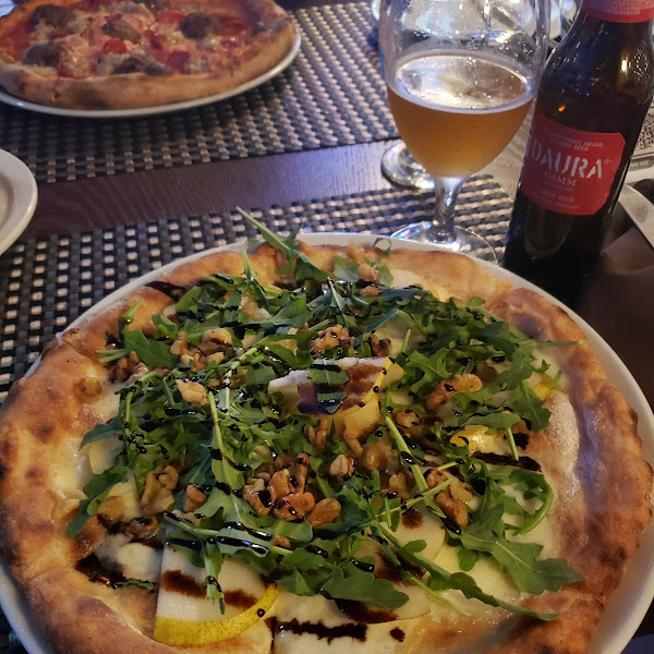 Delicious pizza accompanied with beer!