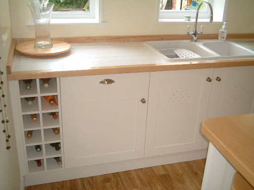 Hand Made Kitchen Designed with customer made and fitted and sprayed to customers own colour, Maple tops with Italian inset tiles flown in from italy.