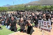 GOD HELP US Protesters pray during a 'Stop the Farm Killings' demonstration in Green Point, Cape Town