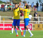 Mamelodi Sundowns' Brazilian defender Ricardo Nascimento (L) celebrates with teammate Tiyani Mabunda after scoring in the 2-1 Absa Premiership win over Baroka FC at Peter Mokaba Stadium in Polokwane the on April 20 2019.