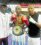 Mziwoxolo Ndwayana (C) celebrates his SA welterweight title victory with his new trainer Lunga Sikonyela after beating Sean Ness. 