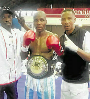 Mziwoxolo Ndwayana (C) celebrates his SA welterweight title victory with his new trainer Lunga Sikonyela after beating Sean Ness.