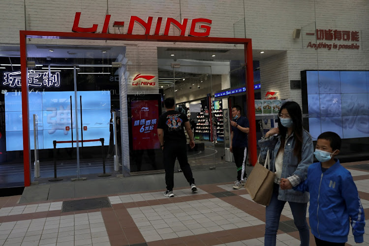 People walk past a store of Chinese sports products brand Li Ning in Beijing, China. Picture: REUTERS/TINGSHU WANG