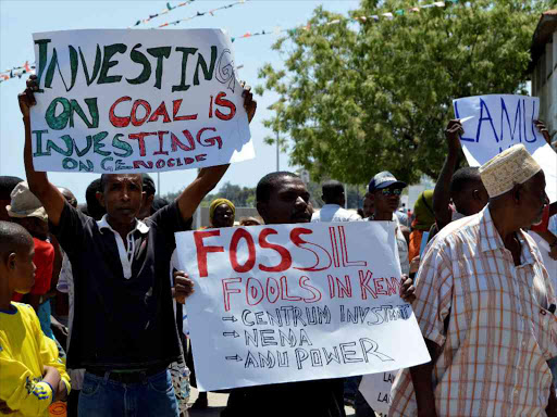 Residents hold placards as they march in a protest against Kenyan government plans to build East Africa's first coal plant near the coastal town of Lamu, December 6, 2016. /REUTERS