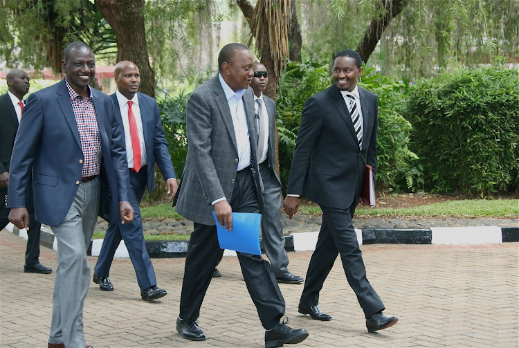 President Uhuru Kenyatta, deputy president William Ruto and the Cabinet Secretary Devolution and Planning Mr. Mwangi Kiunjuri walking to the Summit venue for the Fifth National and County Government Coordinating Summit at State Lodge, Sagana in 2016