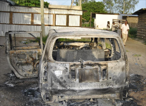 One of the vehicles burnt beyond recognition by the suspected Al Shabaab terrorists at Kibaoni in Mpeketoni. Photo/FILE