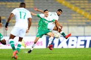 Mohamed Al Makaazi of Raja Casablanca and Abbubaker Mobara of Amazulu challenge for possession in the Caf Champions League match at Stade Mohamed V in Casablanca, Morocco on February 12 2022.