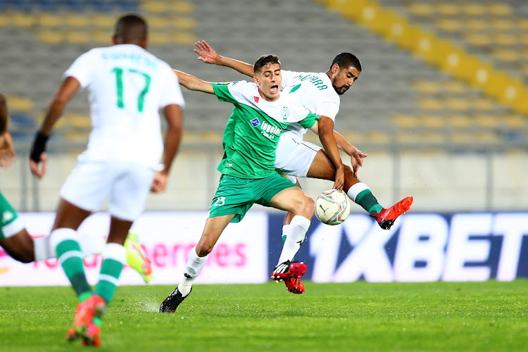 Mohamed Al Makaazi of Raja Casablanca and Abbubaker Mobara of Amazulu challenge for possession in the Caf Champions League match at Stade Mohamed V in Casablanca, Morocco on February 12 2022.