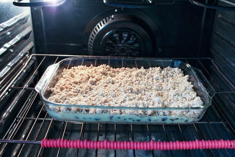 Custard And Crumb Layer Added And Baking In The Oven.