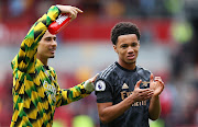 Ethan Nwaneri (right) of Arsenal applauds the fans next to Gabriel Martinelli following the Premier League match against Brentford at Brentford Community Stadium on September 18 2022.